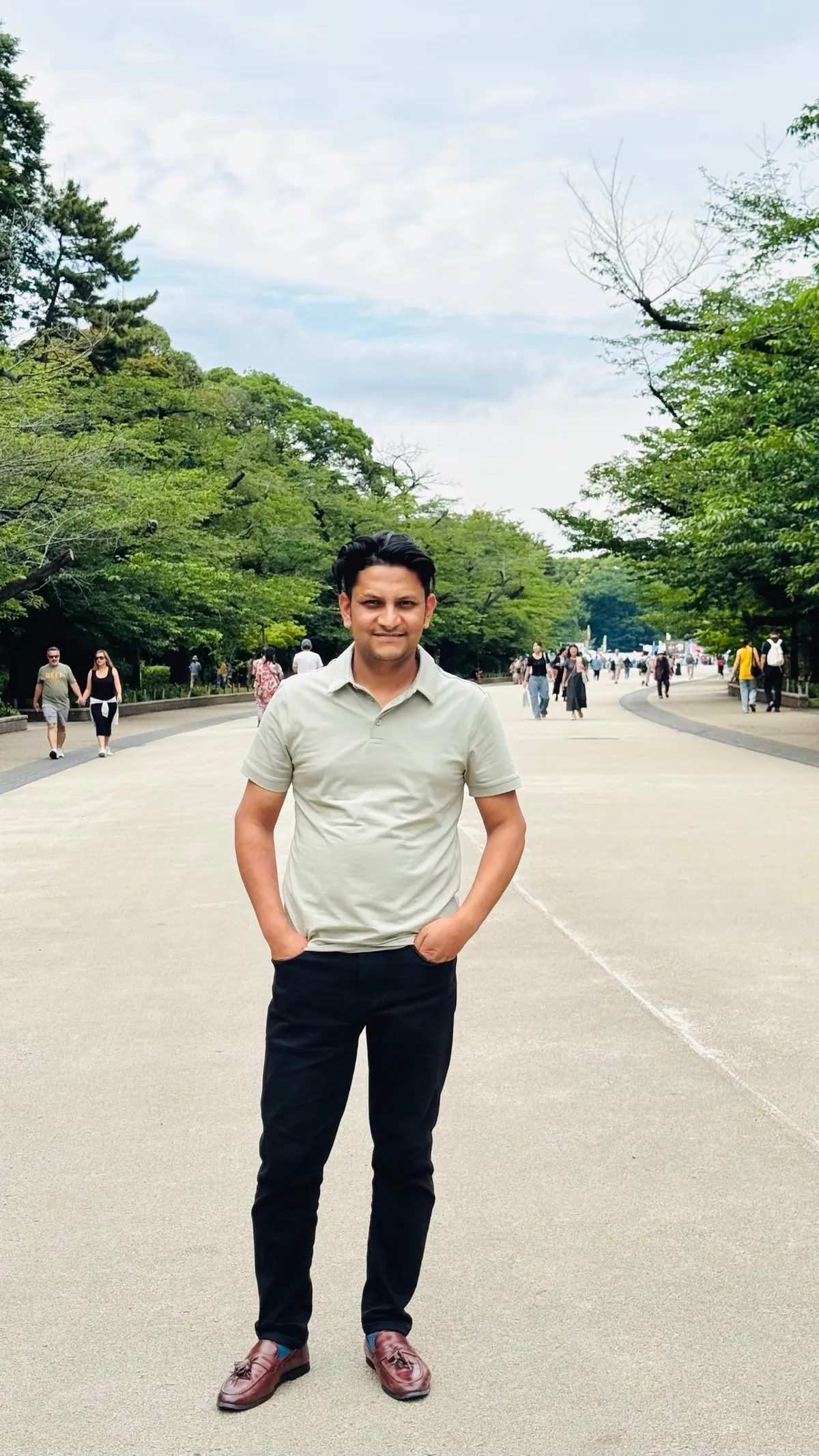 टोकियोको पार्कमा रूखै-रूखले घेरिएको बाटोमा उभिएका कृष्ण प्रसाद अधिकारी